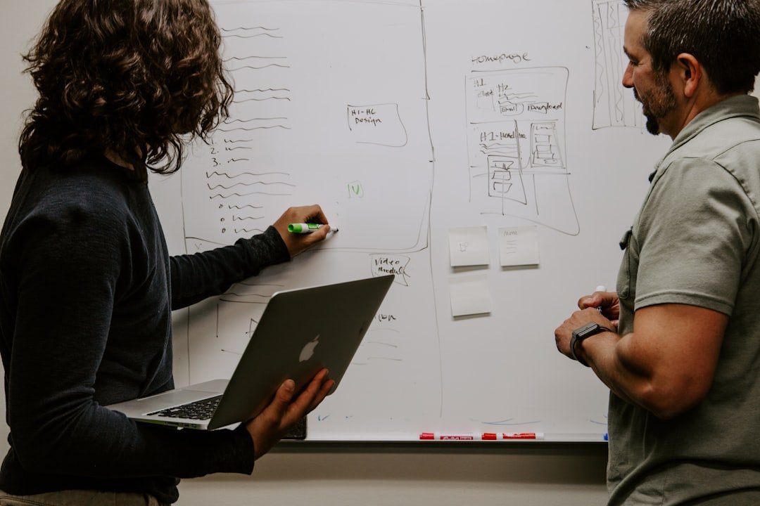 Person mapping out a digital marketing funnel strategy on a whiteboard