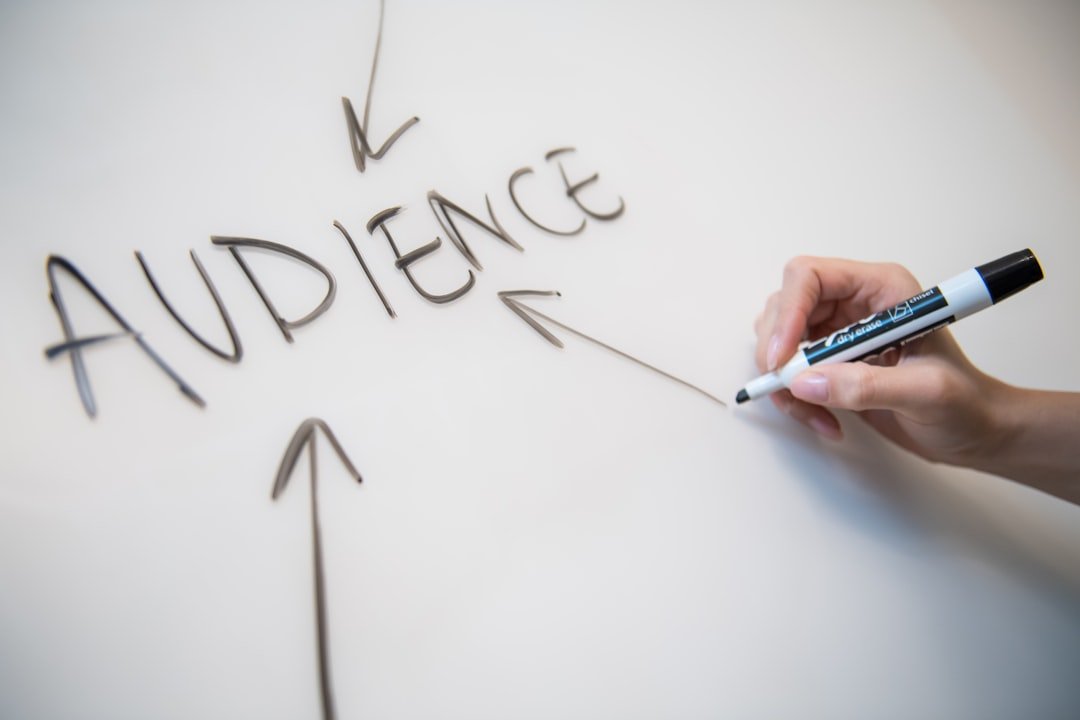 Person mapping a digital marketing funnel strategy on a whiteboard