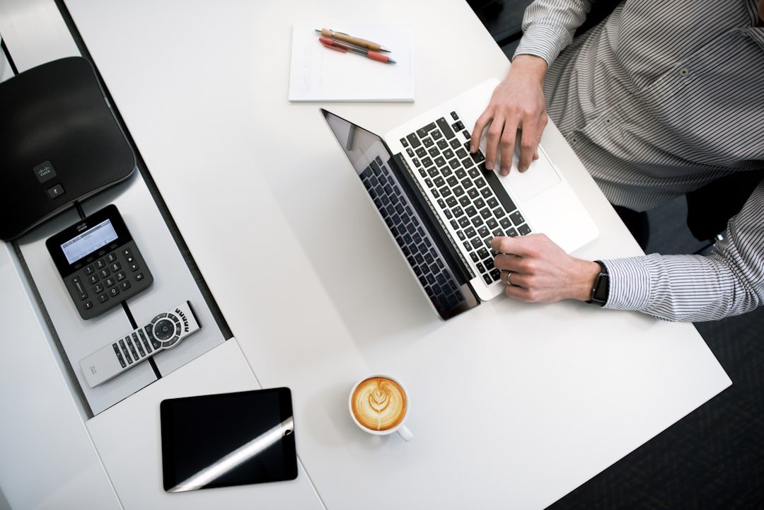 Entrepreneur building AI workflows on a laptop at a minimalist desk