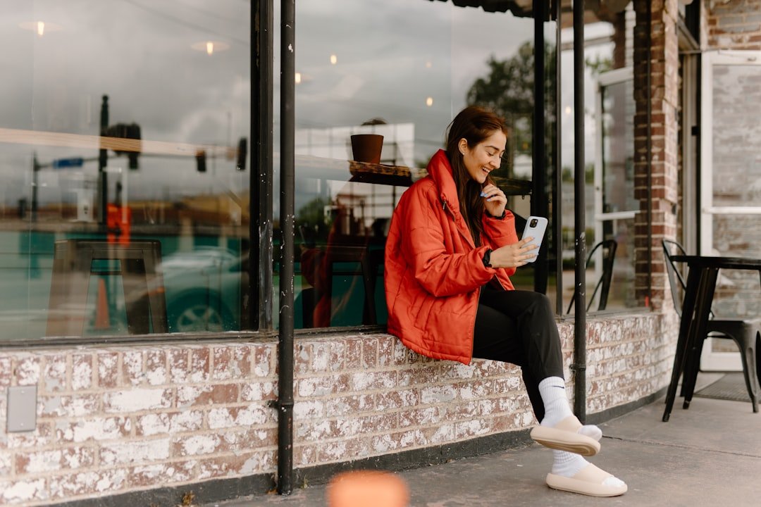 Person scrolling Instagram on a smartphone in a coffee shop