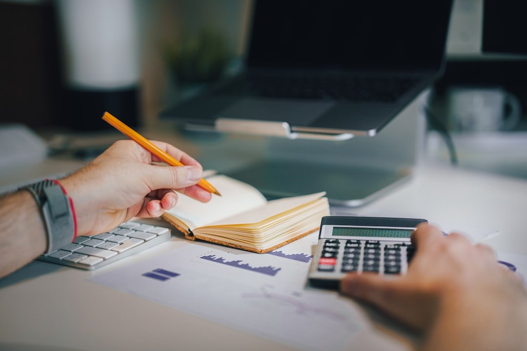 Business owner reviewing real costs of running a US company at a desk with calculator and documents