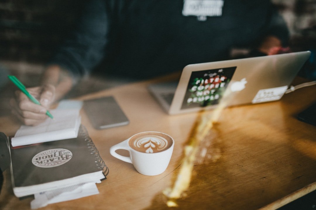 Small business owner using AI tools on a laptop at a desk