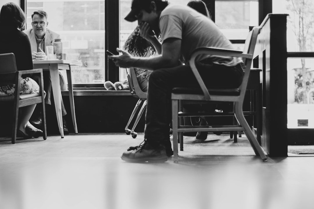Person scrolling Instagram on a smartphone in a coffee shop — grow instagram accounts in saturated niches